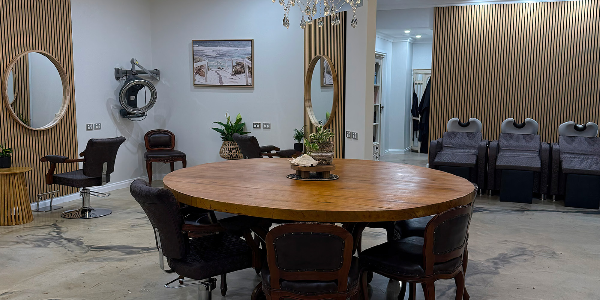 The round timber table and basins inside The Source Hairdressing